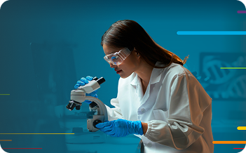 Scientist in a lab coat using a microscope, wearing gloves and safety glasses.