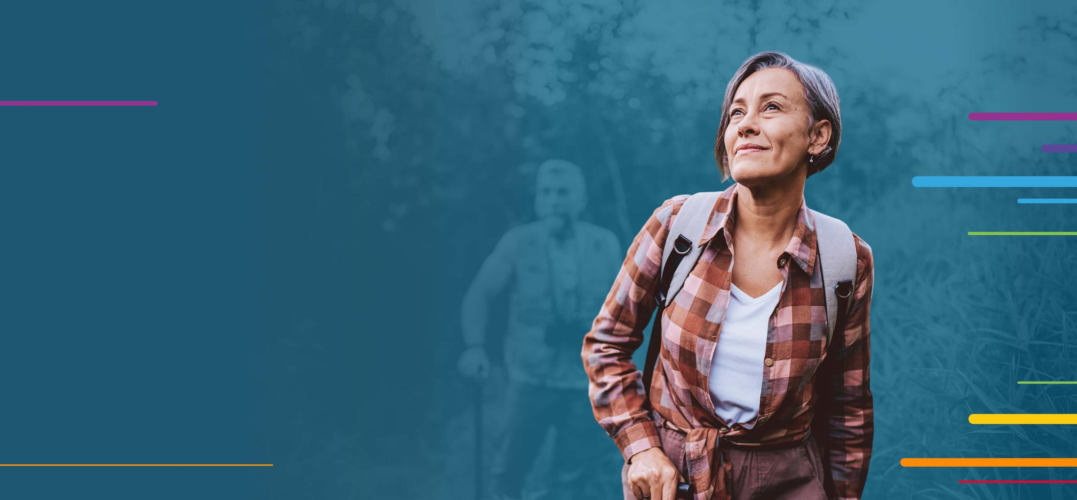 Smiling woman in outdoor clothing hiking with a backpack, forest background.